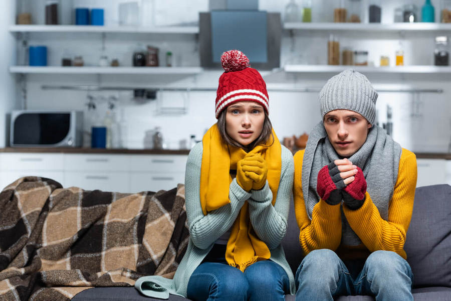 Freezing couple in warm hats and gloves